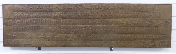 An early 20thC brass frieze of an Ancient Roman battle, with faint details to side,