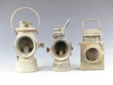 Three various veteran car lamps including King of the Road