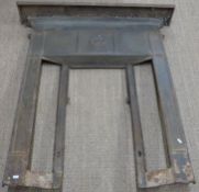 Cast iron fire surround or fireplace together with an oak overmantel