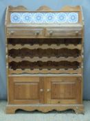 Pine wine rack to house 24 bottles below two drawers, the base having a cupboard,