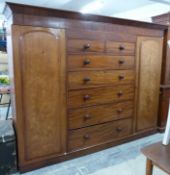 Victorian mahogany compactum with central chest of two over five drawers flanked by wardrobes,