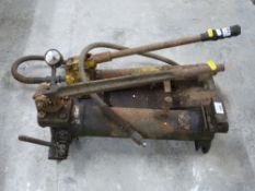 Two hydraulic rams or pumps and a further ram