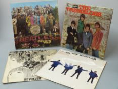 A small case of 16 albums mostly from the 1960s including The Beatles (Pepper, Help, Revolver),