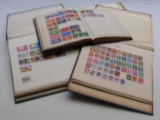 Four albums of all world stamps,