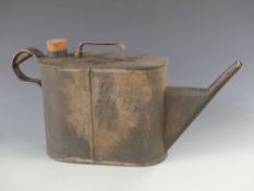 A vintage oil can of watering can form