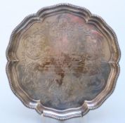 Victorian hallmarked silver salver raised on three feet,