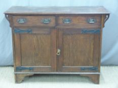 Arts and Crafts / Art Nouveau oak sideboard with hammered hinge straps and similar handles,
