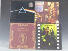 Approximately 30 records in a case including Pink Floyd - Dark Side of the Moon with two posters