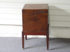 19thC mahogany cellarette raised on square tapering legs,