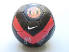 Manchester United football signed by 20 of the team together with facsimile signed 2009-10 card.