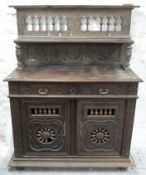 Carved oak sideboard with gallery back and pierced bobbin doors, raised on bun feet,