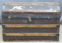 Dome topped wooden bound travelling trunk,