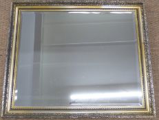Bevelled glass mirror in ornate frame,