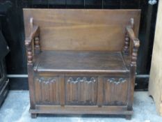 An early 20thC monk's bench with moulded blanket fold decoration