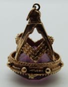 A 9ct gold Masonic fob set with purple paste
