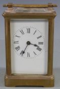 Early to mid twentieth century brass carriage clock in corniche style case, the white enamel Roman
