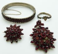 A suite of Victorian Bohemian garnet jewellery comprising brooch, pendant, bangle and ring