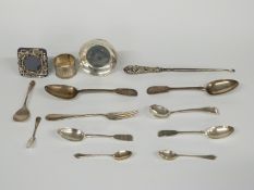 A quantity of Georgian and later hallmarked silver cutlery including fiddle pattern, silver napkin