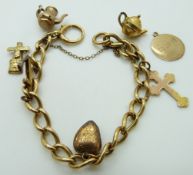 An 18ct gold charm bracelet with a 9ct gold cross, anchor charm, other charms etc, 21.7g