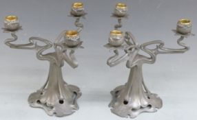 A pair of Art Nouveau pewter three branch candelabra in the style of Archibald Knox, height 26cm
