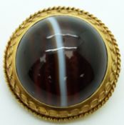 Victorian gold brooch set with a banded agate cabochon in a foiled mount verso a glass compartment