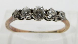 An 18ct gold ring set with five diamonds, size K