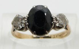 An 18ct gold ring set with an oval sapphire and two diamonds, each approximately 0.25ct, size L