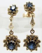 A pair of 9ct gold earrings set with two sapphires and diamonds, 2.5cm drop