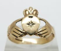 A 9ct gold Claddagh ring set with a diamond , 2.7g, size R