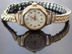 H & G 9ct gold ladies wristwatch with inset subsidiary seconds dial, gold hands and Arabic numerals,