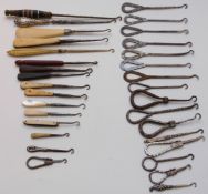 A collection of button hooks including hallmarked silver, mother of pearl handled etc.