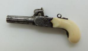 A 19thC miniature pistol with turned and chased barrel and ivory grip, the working hammer action