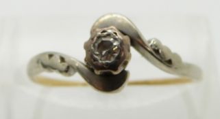 An 18ct gold ring set with a diamond in a platinum setting, size N