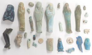 A quantity of Egyptian Shabti figures, amulets, bronze statue part etc