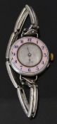 Silver ladies wristwatch with pink guilloché enamel bezel, blue Arabic numerals, silver face,