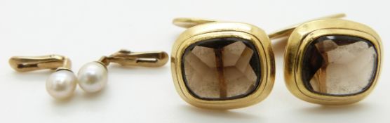 A pair of yellow metal cufflinks set with smoky quartz and pearl studs