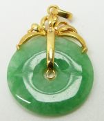 A jadeite disc with 18ct gold pendant fittings