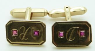 A pair of yellow metal cufflinks each set with two square cut rubies, 8.6g