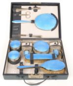 Gentleman's blue guilloché enamel and silver plated dressing table set in leather case, width 30.