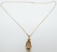 A 9ct gold pendant in the form of a clown set with paste and a 9ct gold chain, 7.44g