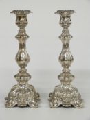 A pair of embossed hollow white metal candlesticks, each only marked 13 in rectangular punch, height