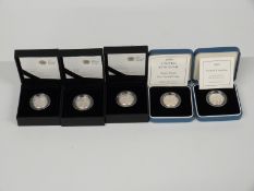 Five silver proof one pound coins including 1999, 2002, 2011 Edinburgh, 2011 Cardiff and 2010
