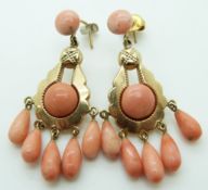 A pair of 9ct gold earrings set with five pear drop coral beads and two coral cabochons to each
