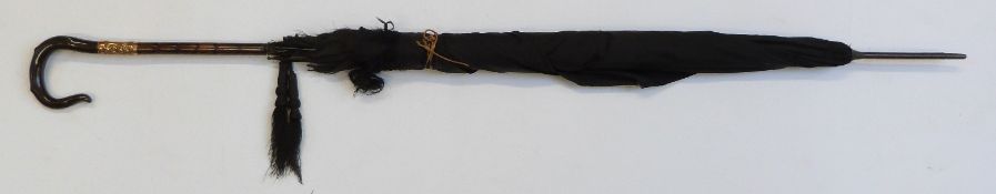 A late 19thC/20thC parasol with horn handle in the form of a crook, yellow metal collar with