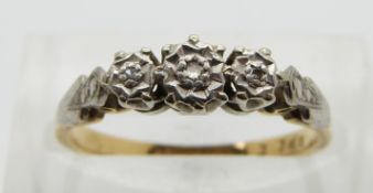 An 18ct gold ring set with three diamonds in a platinum setting, size M