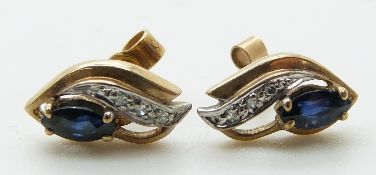 A pair of 9ct gold earrings set with a marquise cut sapphire and diamonds