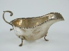 George V hallmarked silver sauce boat raised on three feet, Birmingham 1928 maker Kirwan & Co Ltd,