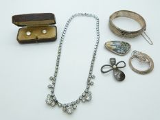 A silver bangle, silver brooches, two cased studs and a diamanté necklace