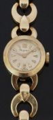 Dugena 14ct gold ladies wristwatch with gold hands and triangular markers, champagne dial and signed