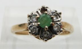 A 9ct gold ring set with an emerald and paste